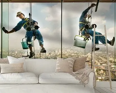 Wyprzedaż Werken op hoogte, glazenwassers hangen aan een wolkenkrabber